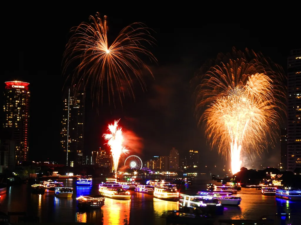 New Year fireworks exploding over Bangkok's skyline at midnight