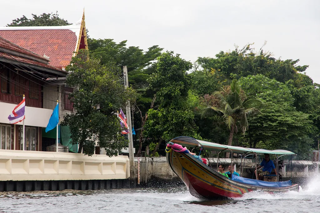 Khlong Bangkok Noi canal with wooden houses and moored boats