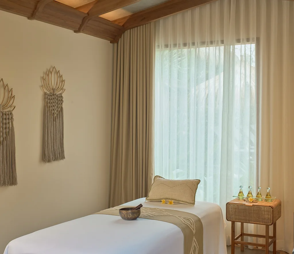 Private spa treatment room with a massage table and soft lighting