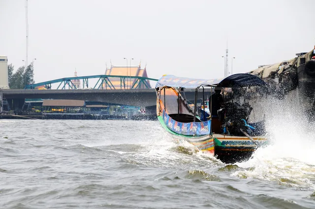 Narrow canal and wooden stilt houses in Bangkok's Thonburi district