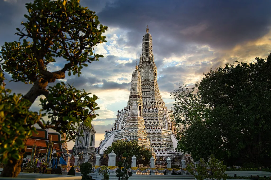 Ornate central prang of Wat Arun temple beside the Chao Phraya River